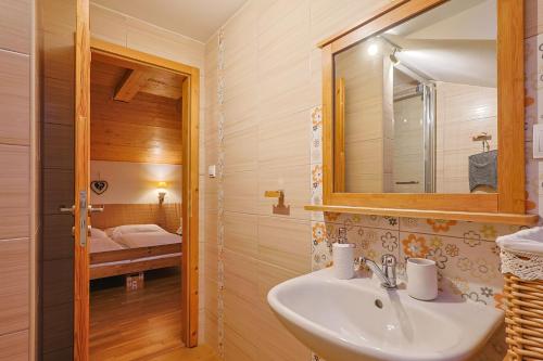 La salle de bains est pourvue d'un lavabo et d'un miroir. dans l'établissement Apartmány Anička ubytovanie region Liptovský Mikuláš, à Liptovské Matiašovce