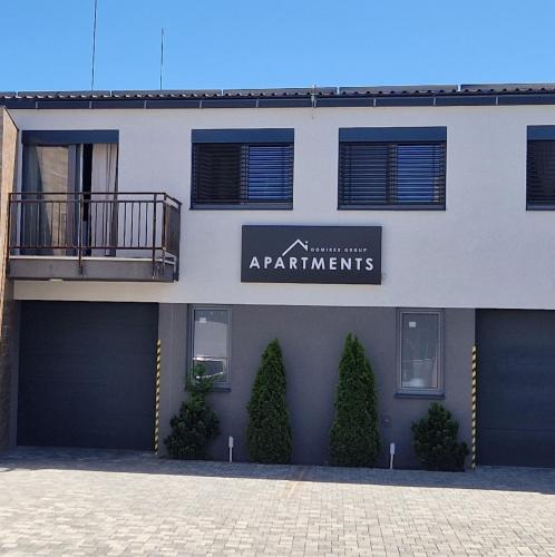 a building with a sign that reads apartment apartments at DomirexGroup Apartments in Lučenec