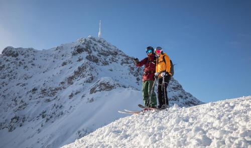 two people standing on top of a snow covered mountain at Achenblick in Sankt Johann in Tirol