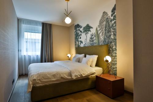 a bedroom with a bed and two lights on at Sun Hill Luxury Suites in Budapest