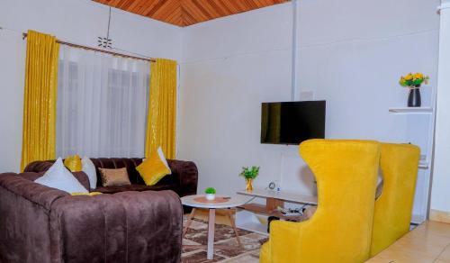 a living room with a couch and a table at Perfection in Meru
