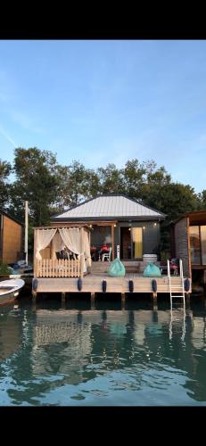 a house on a dock on a body of water at Barbana Cottage , Ada Bojana in Ulcinj