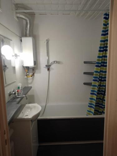 a bathroom with a tub and a sink and a shower at Apartament 4 in Przemyśl