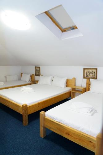 a group of three beds in a room at Hostel km 0 in Bucharest