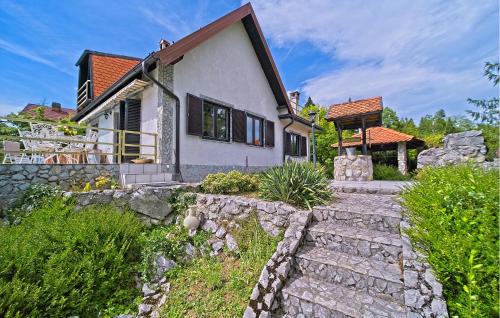 a house with a stone path leading up to it at Cozy Home In Donji Zvecaj With Kitchen in Donji Zvečaj