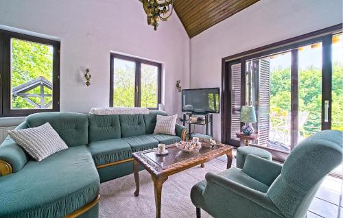 a living room with a couch and chairs and a table at Cozy Home In Donji Zvecaj With Kitchen in Donji Zvečaj