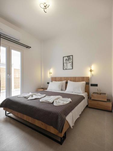 a bedroom with a large bed and a large window at Parikia's Urban Oasis in Parikia