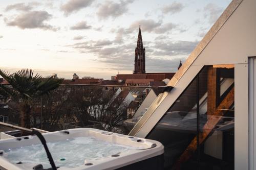 a bath tub on a balcony with a view of a city at Historical Luxury Homes - Exclusive Selection in Freiburg im Breisgau