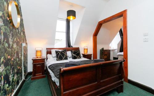 a bedroom with a bed and a mirror at Carlton Hotel in Forres