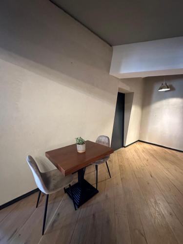 a dining room with a wooden table and chairs at Mulhouse City Loft in Mulhouse