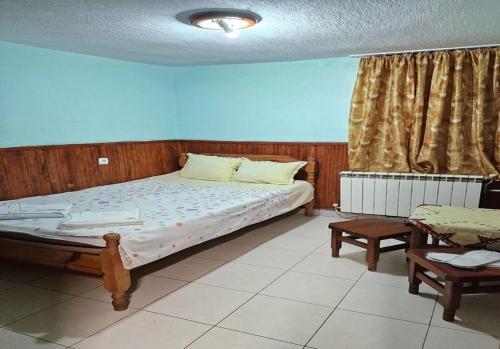 a bedroom with a bed in a room at Хотел Механа Воденицата in Zlatkov Chiflik