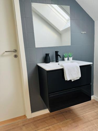 a bathroom with a sink and a mirror at KonceptHotel in Oksbøl