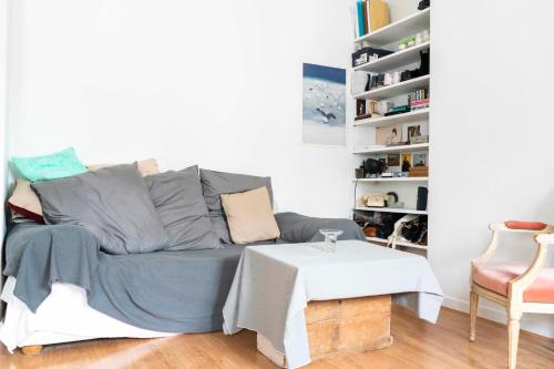 a living room with a couch and a table at Cozy studio 2 steps from the Eiffel Tower in Paris