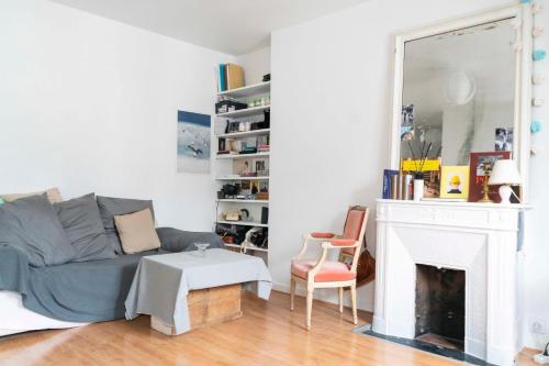 a living room with a couch and a fireplace at Cozy studio 2 steps from the Eiffel Tower in Paris