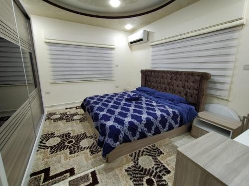 a bedroom with a bed in a room with a rug at زريقات للشقق المفروشه in Irbid