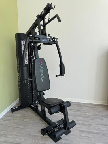 a gym equipment machine with a treadmill at KonceptHotel in Oksbøl