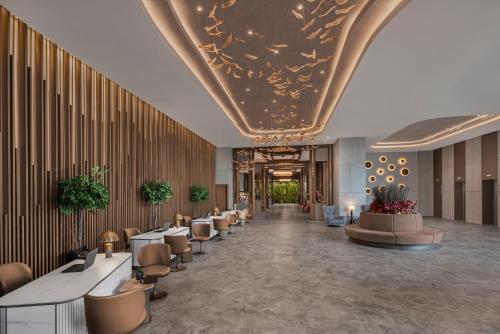 a lobby with a long line of tables and chairs at NG Enjoy in Sapanca