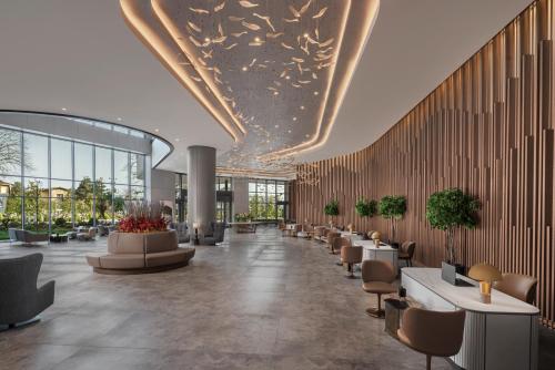 a lobby of a building with tables and chairs at NG Enjoy in Sapanca