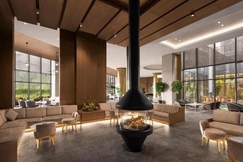 a lobby with couches and tables and windows at NG Enjoy in Sapanca