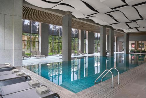 a large swimming pool with blue water in a building at NG Enjoy in Sapanca