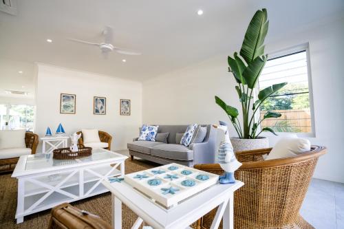 a living room with a couch and a table at Trinity Collective in Trinity Beach