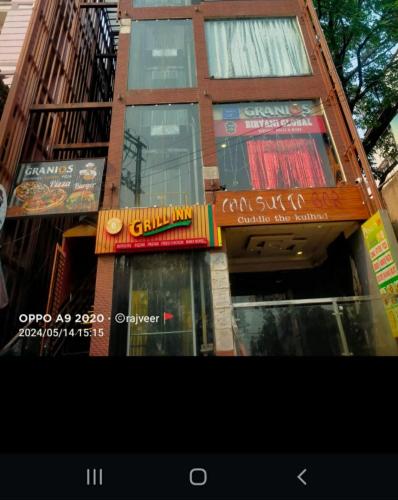a building with signs on the side of it at Hotel 27 degree in Dhanbād