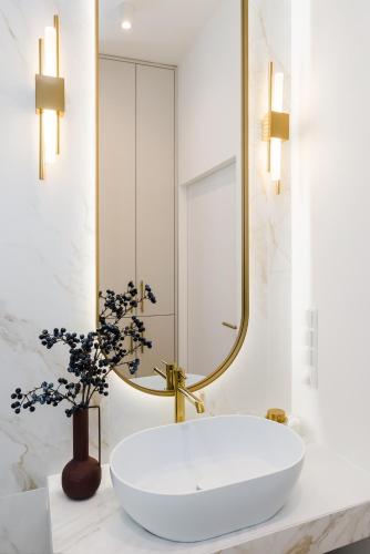 a bathroom with a white tub and a mirror at Sol Marina Resort Wyspa Sobieszewska II - LoftAffair Collection in Wiślinka