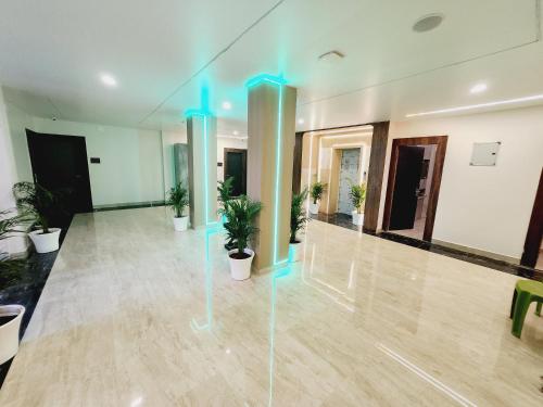 an empty room with blue lights on pillars at THE GREENSTAR INN PREMIUM in Bhubaneshwar
