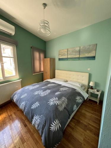 a bedroom with a large bed in a room with green walls at Old Town Home Ioannina in Ioannina
