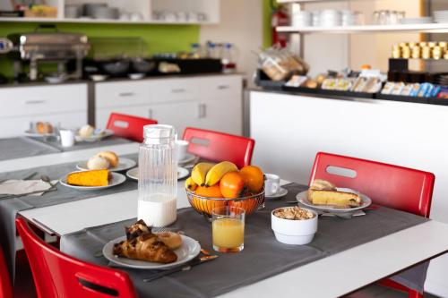 a table with plates of food on it in a kitchen at Hotel Campus Sanpaolo in Turin