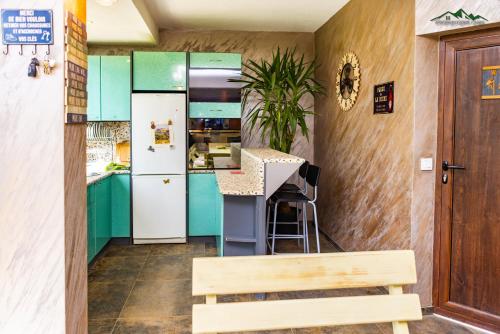 a kitchen with green cabinets and a white refrigerator at Докторската къща in Sapareva Banya