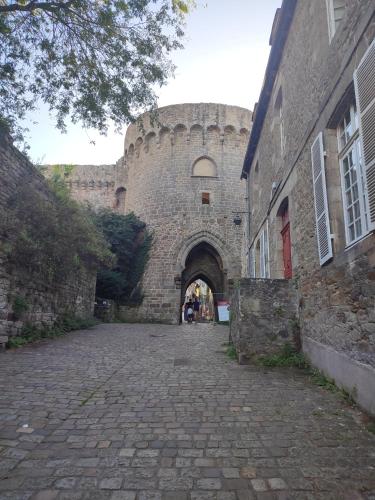 an entrance to a large brick building with a tunnel at Gite des Mézières in Brusvily