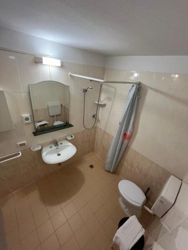 La salle de bains est pourvue de toilettes, d'un lavabo et d'un miroir. dans l'établissement HOTEL ITALIACERVIA Free Breakfast, à Cervia
