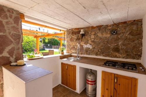 a kitchen with a sink and a counter top at Malomvölgyi Vendégház in Balatonalmádi