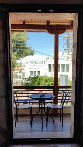 a patio with a table and two chairs on a porch at Stella's House in Kassandria