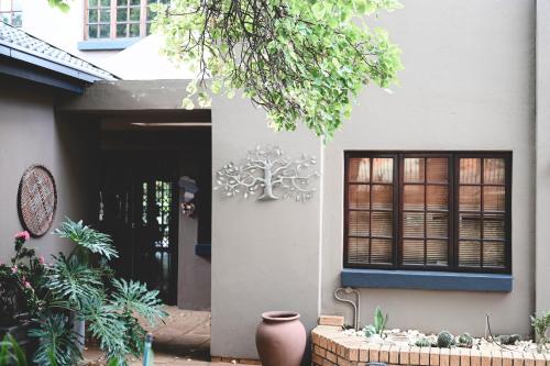 a house with a vase in front of a door at The Red door in Rustenburg