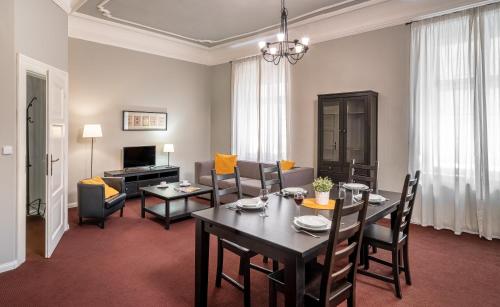 a living room with a table and a dining room at Hotel "Palác U Kočků" by Adrez, Palace At the Cats in Prague