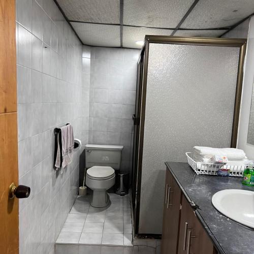 a bathroom with a toilet and a sink at Casa Familiar- Turística Manríque Medellín in Medellín