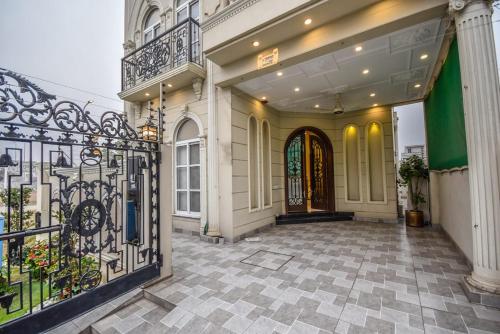 an entrance to a house with a wrought iron gate at Luxury New Designer 3 BDRM Entire Home DHA Lahore Near Airport in Lahore