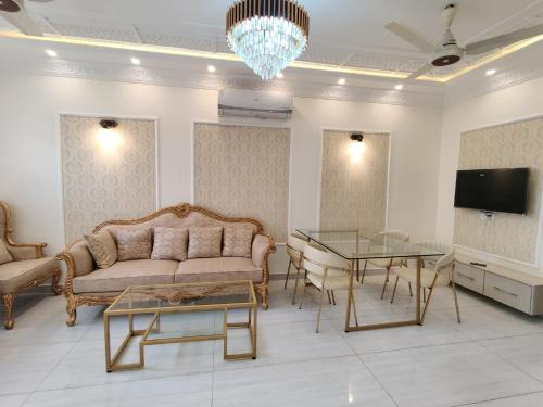 a living room with a couch and a table at Luxury New Designer 3 BDRM Entire Home DHA Lahore Near Airport in Lahore