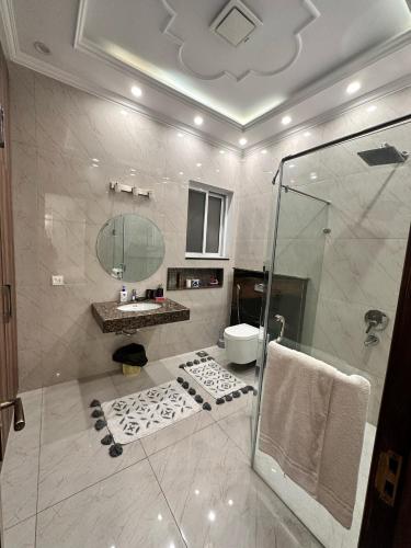 a bathroom with a shower and a sink and a toilet at Luxury Dream Vacation Home in DHA Near Lahore Airport in Lahore