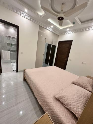 a bedroom with a large bed in a room at Luxury Dream Vacation Home in DHA Near Lahore Airport in Lahore