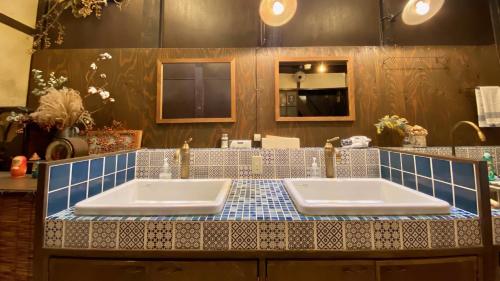 a bathroom with two sinks and a blue tiled counter at Guesthouse Kioto in Kyoto