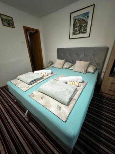 a bed with two pillows on it in a room at Guest House Nana in Mostar
