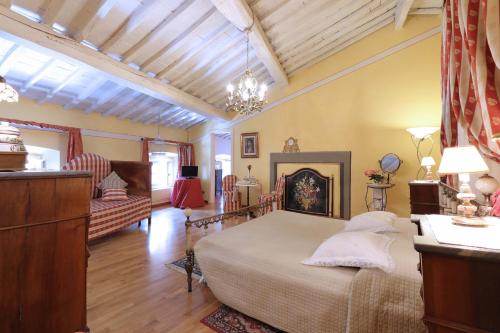 a bedroom with a bed and a fireplace at Antica Dimora Patrizia in Montecarlo