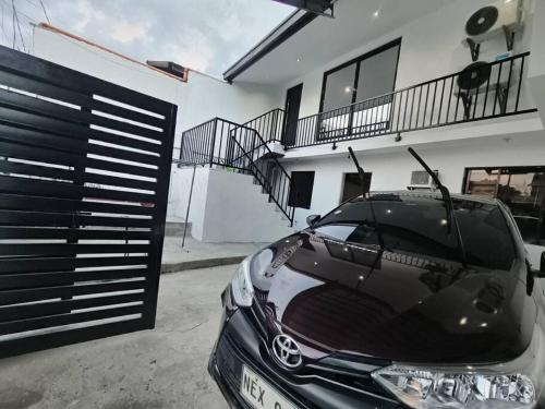a black car parked in front of a house at The White House in San Mateo