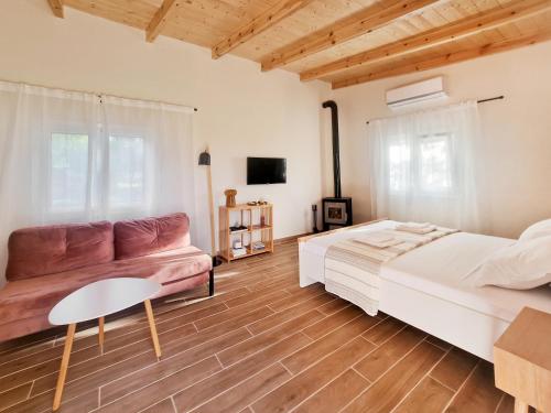 a bedroom with a bed and a couch at Cozy Owl's Studio Home in Pyrgos