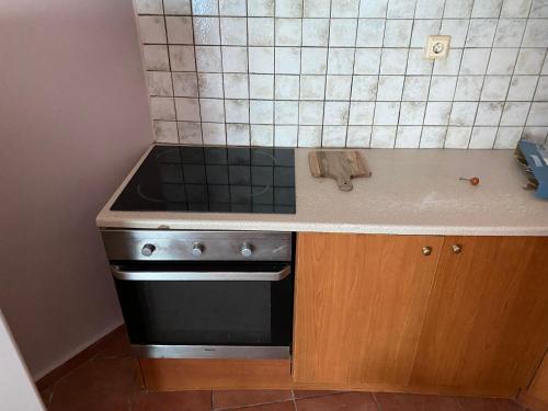 a kitchen with a stove and a counter top at Μεζονέτα Τοξότης in Chios