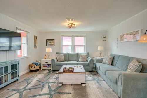 a living room with a couch and a table at Updated Kitty Hawk Semi-Oceanfront with Ocean Views in Kitty Hawk