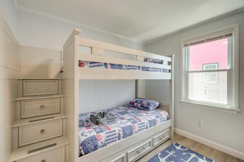a bedroom with bunk beds and a window at Updated Kitty Hawk Semi-Oceanfront with Ocean Views in Kitty Hawk